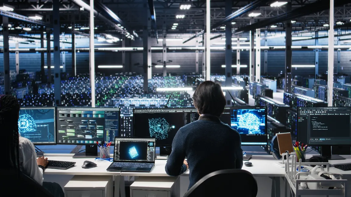 a man watches over a large datacenter from a security post