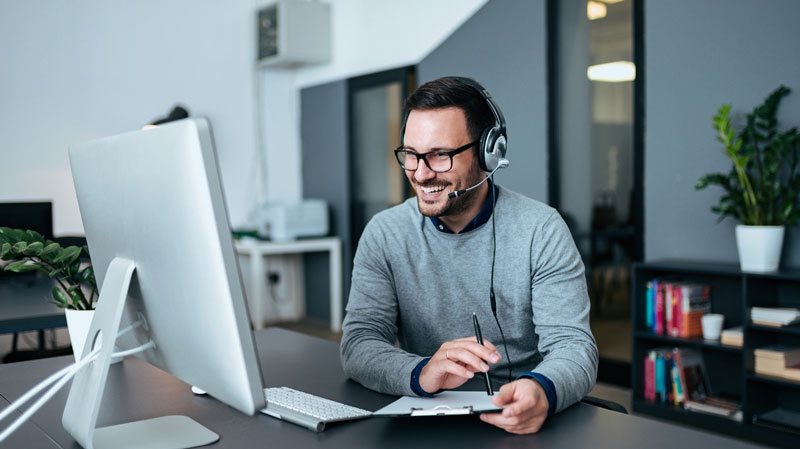 man smiling at the computer
