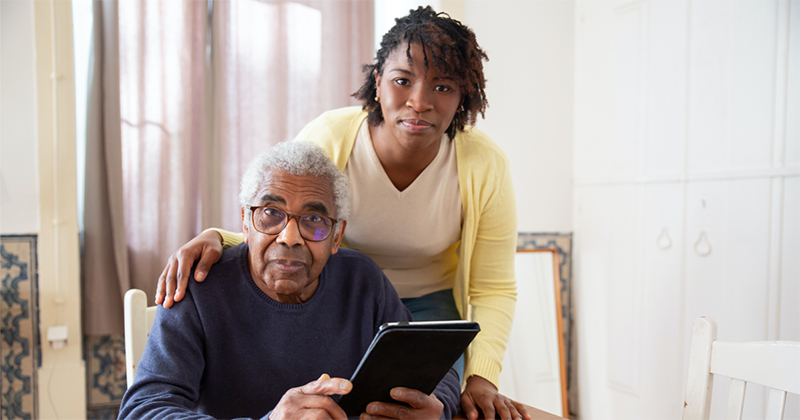 Senior holding a tablet