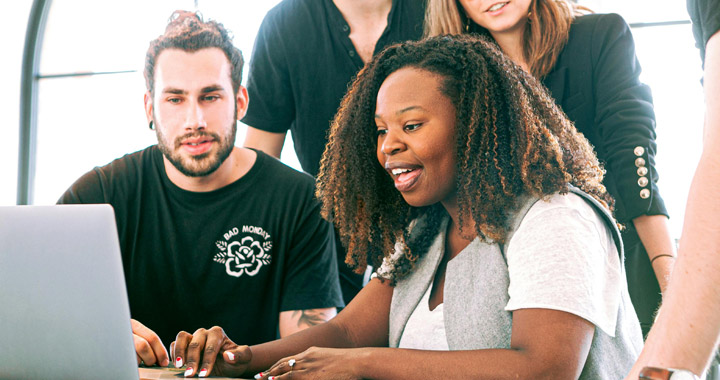 Group of people using a laptop